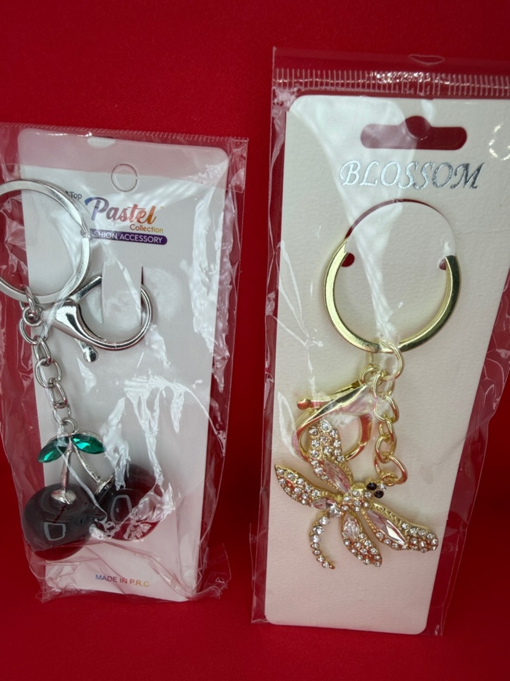 NWT SeT 2 keychains, or bag charms, dragonfly, and red cherries. Great gifts.!